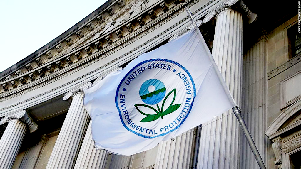 A flag of the United States Environmental Protection Agency (EPA) waving in front of a building with classical columns