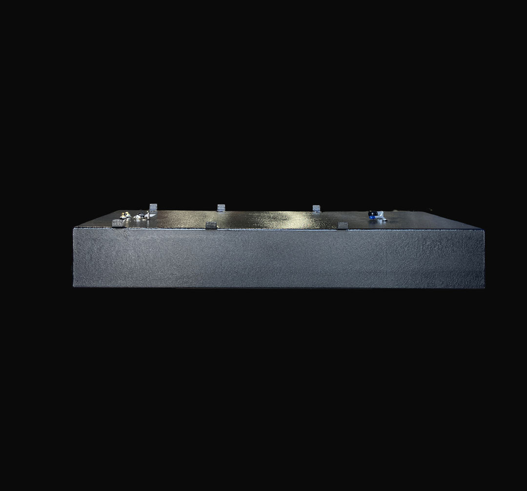 A straight-on side elevation studio view of the opposite side of a physical, finished black encapsulated Sport Craft 25 WA 1994 OEM replacement marine fuel tank from file image_9a0907.jpg, isolated against a black background. This alternative side-profile perspective emphasizes the tank's low rectangular profile and the thick, protective, textured black TarGard epoxy coating applied over the heavy-gauge marine-grade 5052-H32 aluminum tank shell to provide maximum resistance against saltwater pitting and bil