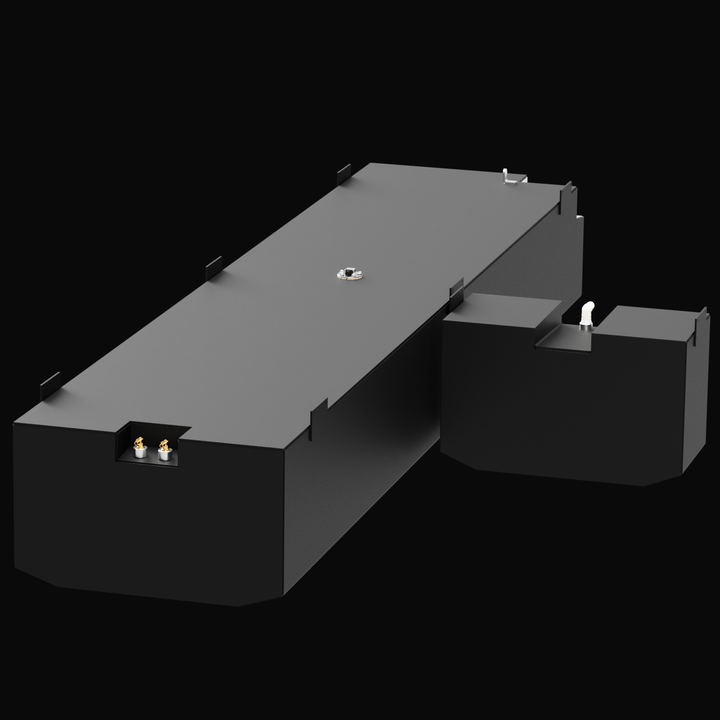 A 3D render of a dark grey boat fuel tank assembly with a stepped design, consisting of a long rectangular main body and an attached, smaller raised section. The tank has various silver and brass-colored fittings and mounting tabs on its top surface, against a black background.