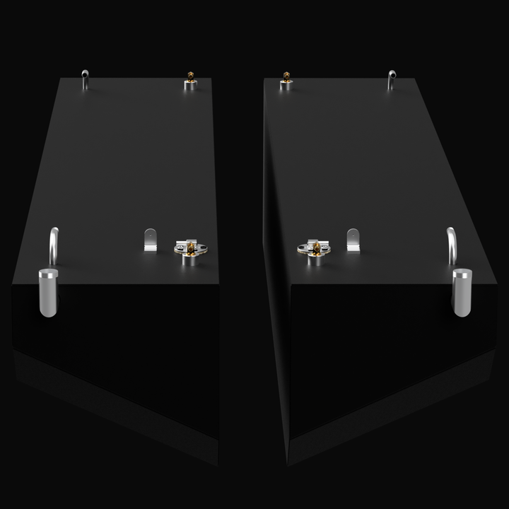 A 3D render showing a pair of identical, dark grey boat fuel tanks side-by-side, angled to show the top and end. Each tank has multiple silver and brass-colored fittings on its top surface, all against a black background.