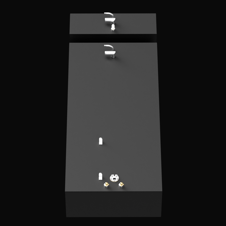 Top-angle 3D render of two black rectangular tanks—one long and one shorter—positioned adjacently. This view clearly displays the arrangement of various metallic fittings on the top surfaces of both tanks, set against a plain black background.