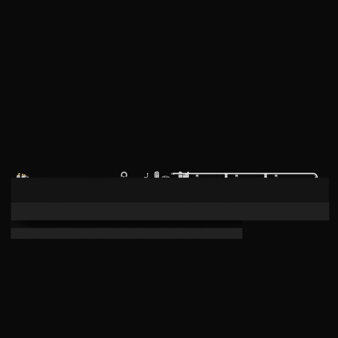 Side view of a large black fuel tank with various metallic fittings and pipes along the top edge. The tank has a rectangular shape with a stepped bottom section, shown against a black background.