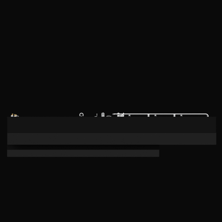 Side view of a large black fuel tank with various metallic fittings and pipes along the top edge. The tank has a rectangular shape with a stepped bottom section, shown against a black background.