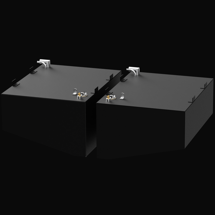 Two black rectangular fuel tanks labeled for a Formula 27 PC 2007, positioned side by side. Each tank has fittings and connectors on the top surface, with metal brackets on the edges. The tanks are set against a black background