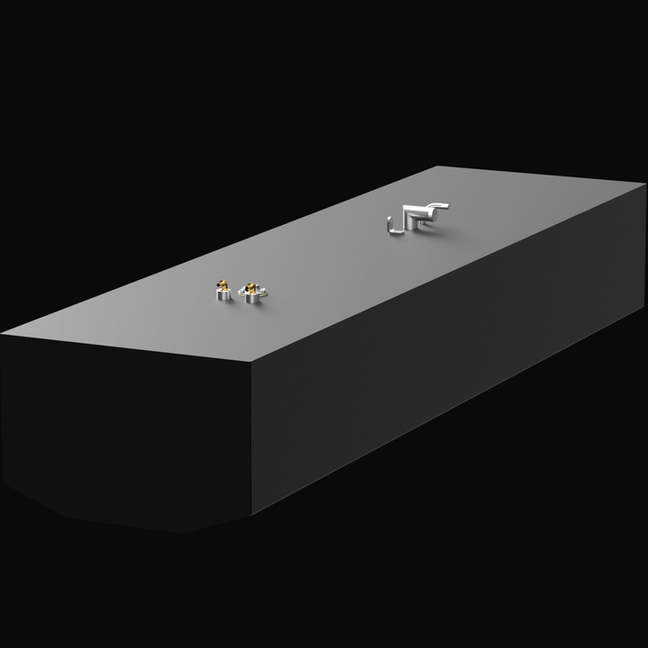 A 3D render of a long, rectangular, dark grey boat fuel tank, shown at an angle. The tank features two clusters of silver and brass fittings on its top surface, against a black background.