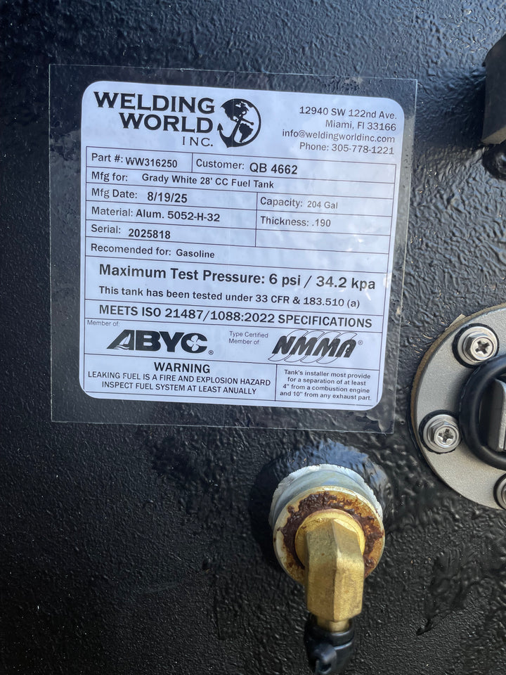 A close-up of a white specification label on a dark textured boat fuel tank. The Welding World Inc. label lists the part as WW316250, manufactured for a "Grady White 28' CC Fuel Tank," with a 204-gallon capacity.