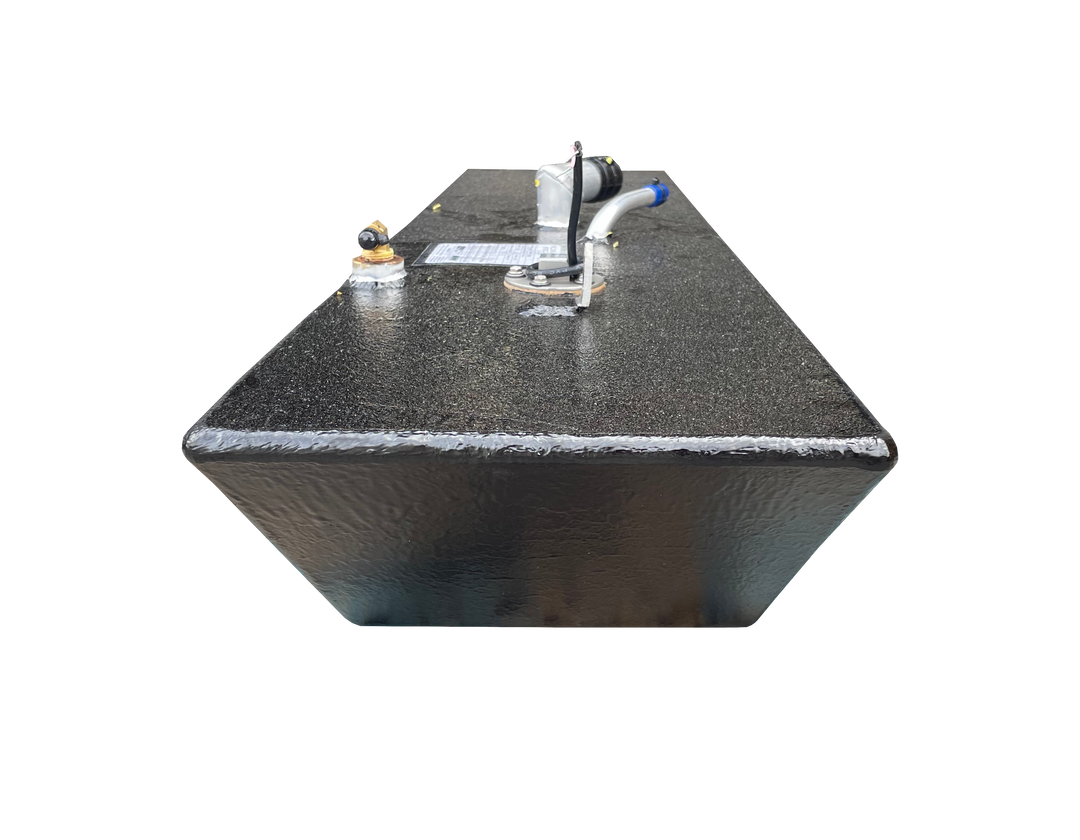 A low-angle photo of a long, dark, textured boat fuel tank, showing the front end and top surface. Various fittings, including a fuel sending unit and valve connections, are visible against a transparent checkerboard background.