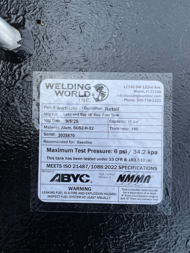 A close-up of a white specification label on a dark textured boat fuel tank. The Welding World Inc. label lists the part as WW316250, manufactured for a "Lake and Bay 18' Aux. Fuel Tank," with a 17-gallon capacity.