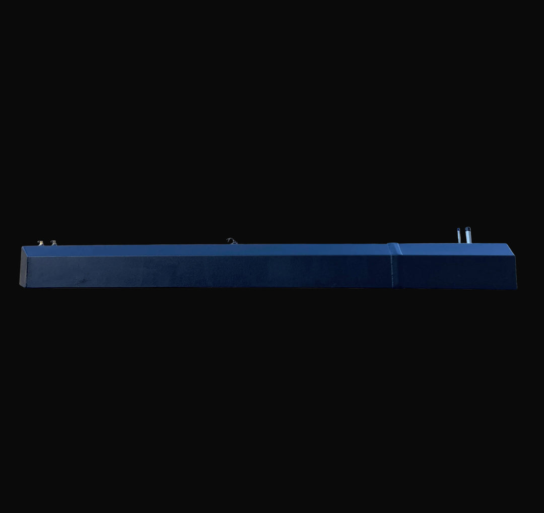 Side elevation view of the Seacraft 32 replacement fuel tank, strictly profiling the stepped hull-contour design. The image captures the full length of the black-coated aluminum unit with fill and vent fittings visible on the top right.