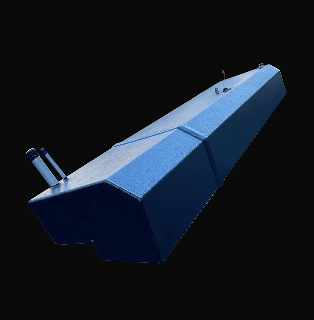 Perspective view of the Seacraft 32 replacement fuel tank, capturing the full elongated shape and custom notched profile. The image focuses on the near-end fill and vent fittings, set against the durable black-coated aluminum finish.