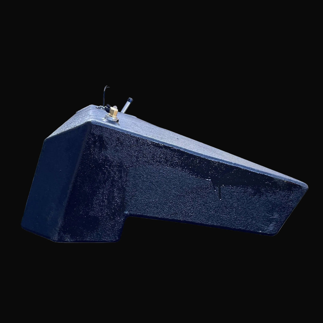 End profile view of the Seacraft 32 fuel tank, displaying the specific notched hull contour and angled bottom. The detailed shot highlights the texture of the black protective coating and the position of the top-mounted brass and aluminum fittings.