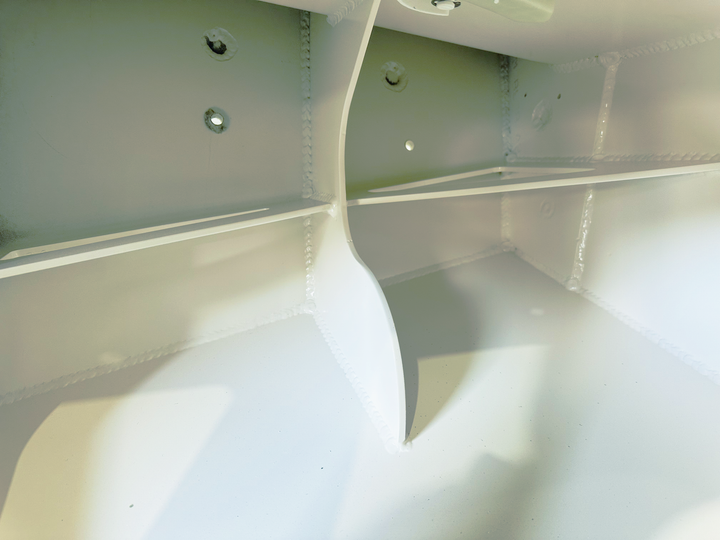 A close-up image of a circular metal plate with a threaded bolt in the center, mounted on a white surface. The plate has the words "Marlon," "The World's Greatest Marine," "MAN," "CMR 3," and a barcode visible on it