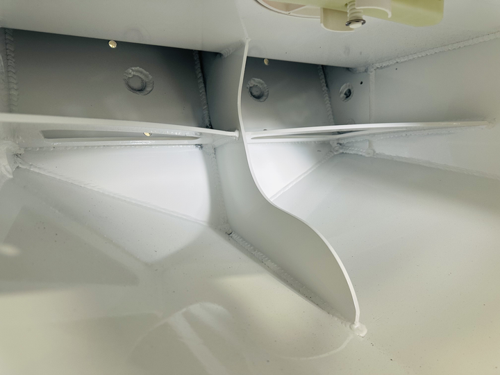 Interior view of a 2004 Grady White 209 High Flotation Single boat, showcasing the smooth, white hull with curved sections and mounting points