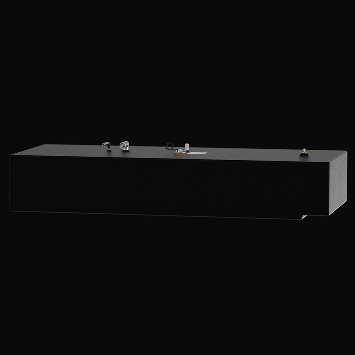 Side-perspective 3D rendering of a long, matte black marine-grade aluminum fuel tank with a textured coal-tar epoxy finish, featuring a row of top-mounted stainless steel fuel fittings and a pre-installed KUS sending unit on a solid black background.