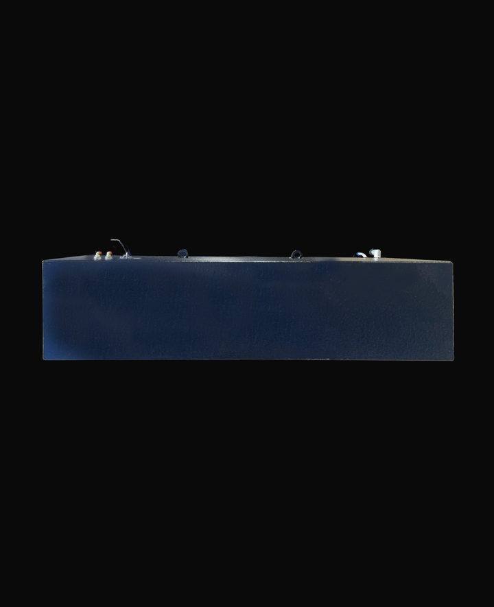 A long side profile photo of a dark, textured boat fuel tank, showing various fittings and D-rings on its top surface, against a black background.