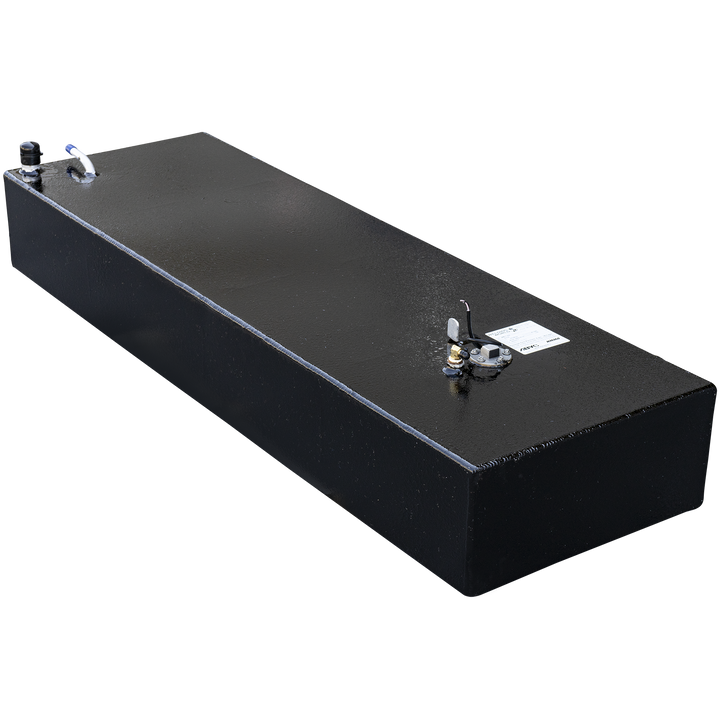 A long, rectangular, black fuel tank with a textured surface. Various metal fittings are visible on its top, including a black and white hose connection with a blue cap, a small black post, and a circular gauge with wires and a white label
