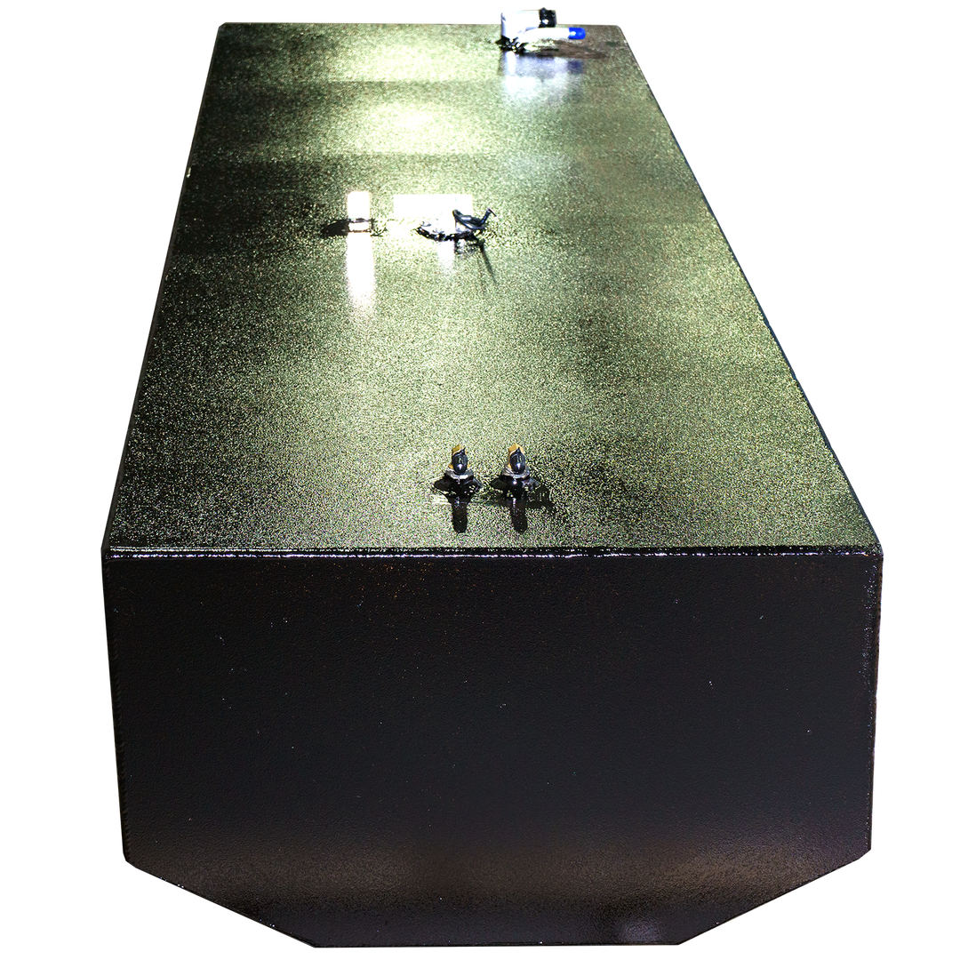 A close-up, elevated view of a black metal box with a subtly textured, glittery top surface. Several small, metallic fixtures are attached to the surface, and a single pipe extends from the top right. Reflections of light are visible on the surface. The background is a checkered pattern of black and transparent squares