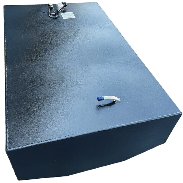 A dark, rectangular fuel tank with a textured surface is positioned at an angle against a black and grey checkered background. On its top surface, there are various fittings including a small curved pipe with a blue tip on one end, and a cluster of several nozzles and a white label on the other