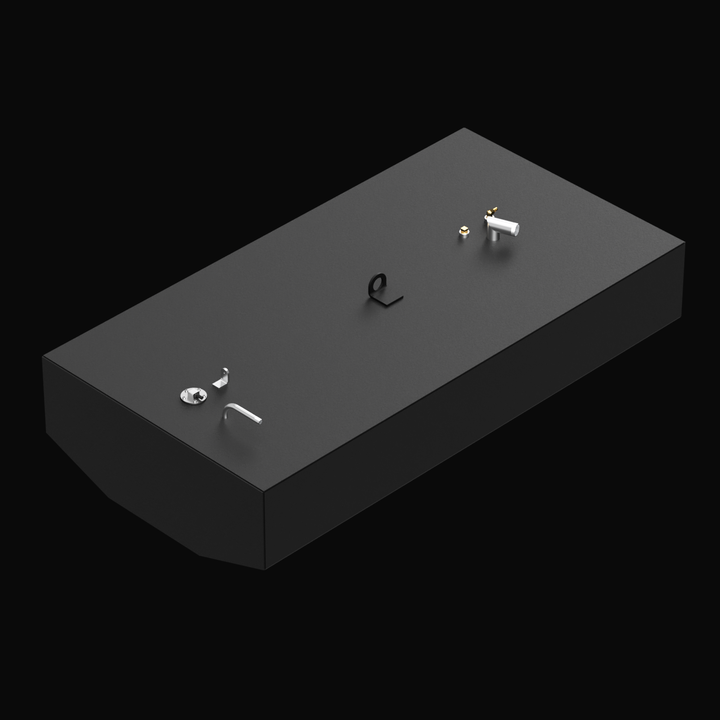 3D rendered image of a rectangular Built to OEM Specs fuel tank with a matte black finish. The tank has a beveled front edge and various fittings and brackets on top. The background is black.