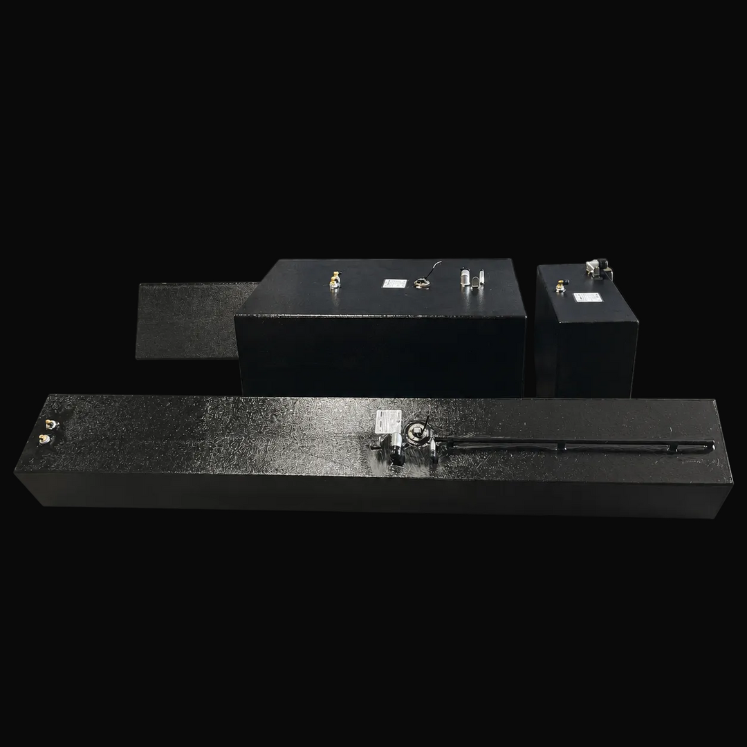 A straight, elevated side-angle perspective view of a four-tank Contender 32 multi-tank replacement marine fuel system combo from file image_a1d6c0.jpg, isolated against a black background. This alternative layout view showcases a single elongated, asymmetrical outboard saddle tank prominently positioned in the foreground, with the large central main belly fuel cell, the matching auxiliary center tank, and the second outboard saddle tank arranged clearly behind it. Precision-fabricated from heavy-gauge mari
