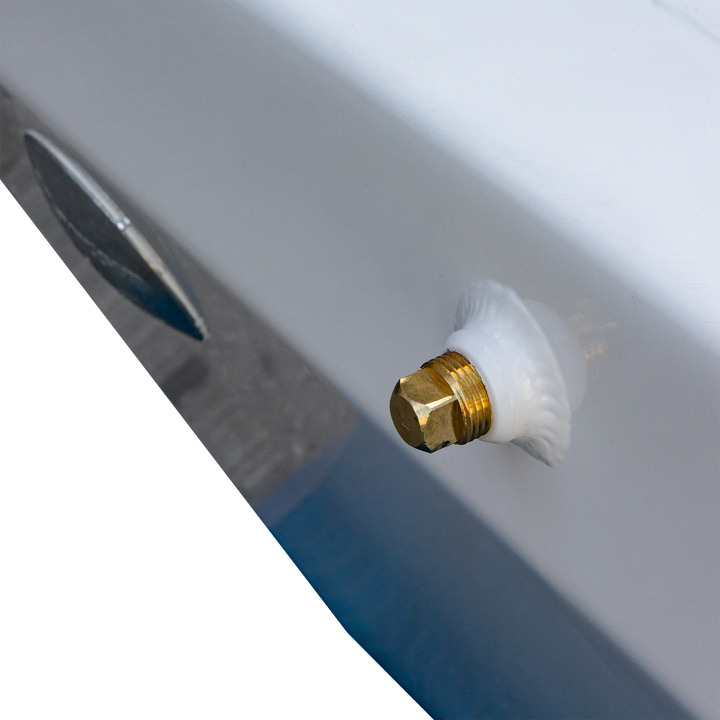 Close-up image of a brass fitting with a white sealing washer, attached to a smooth, white surface, likely part of a custom build for an Apex Mk. II twin engine bracket. The background is blurred, emphasizing the fitting