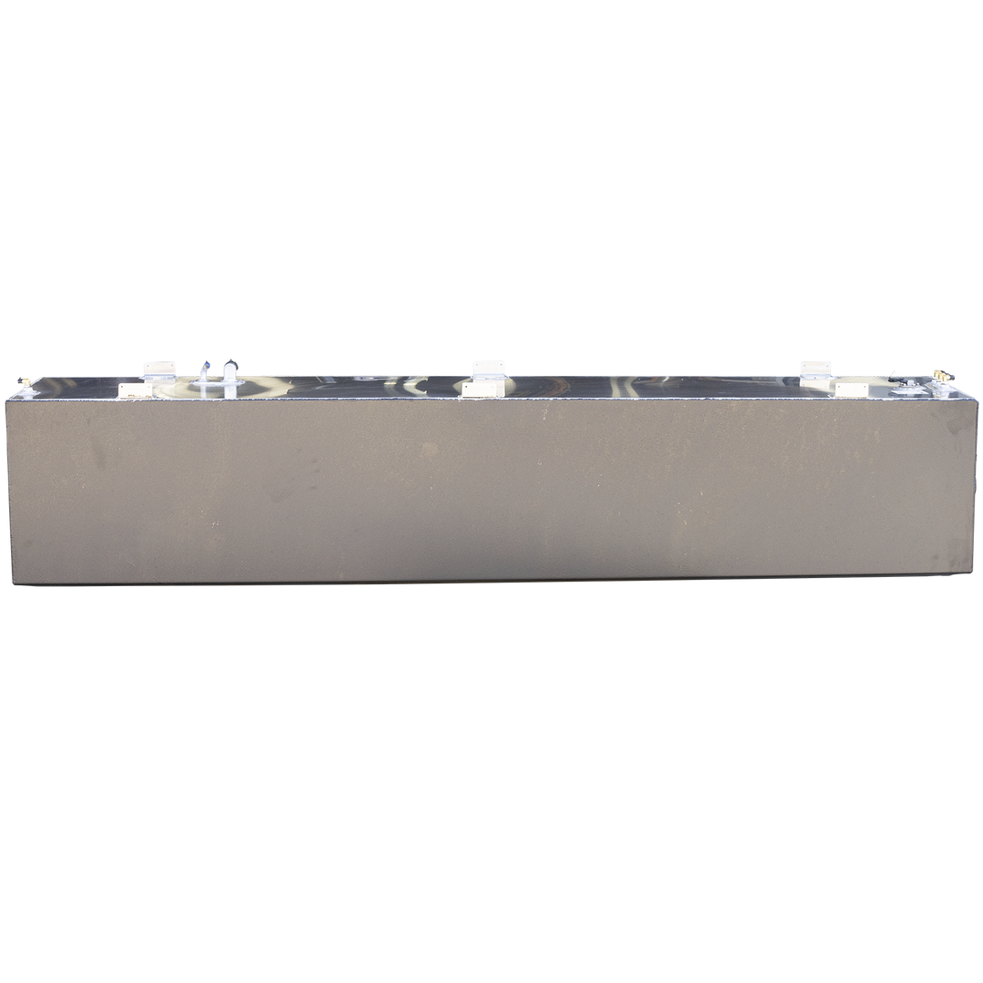 This image shows a large, rectangular aluminum fuel tank viewed from the front side with the top surface facing upward. The tank has a smooth, metallic finish with a slight sheen and visible weld seams along the edges. The top surface is fitted with several mounting brackets evenly spaced along the length of the tank. On the right side of the top surface, there are multiple fuel fittings including two white pipe connectors and a circular metal cap