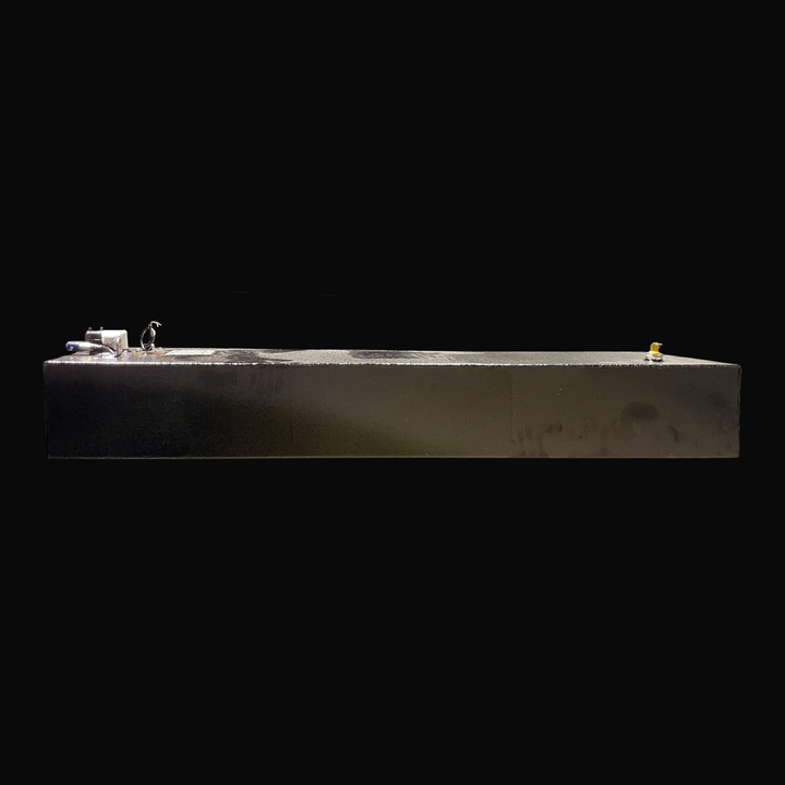 An eye-level studio side profile view displaying the full length of a physical, finished black encapsulated Eagle 17 OEM replacement marine fuel tank (29 gal 2000) from file image_495dc3.jpg, isolated against a black background. Precision-fabricated from heavy-gauge marine-grade 5052-H32 aluminum, the long low-profile rectangular body is fully encapsulated in a protective, textured black TarGard epoxy coating to prevent severe saltwater pitting and bilge moisture accumulation. Visible top deck hardware incl