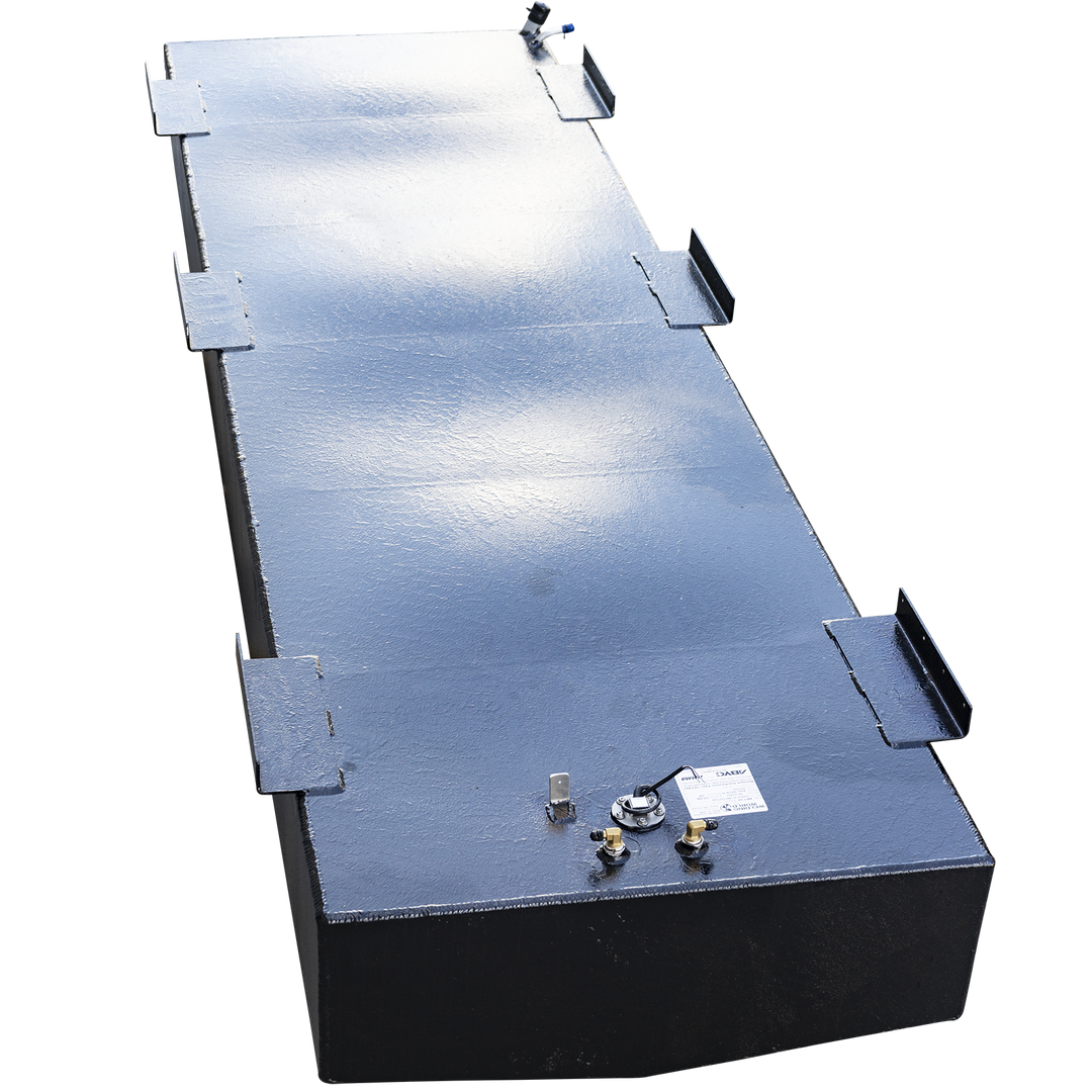 A high-angle view looking down the entire length of a very long, rectangular boat fuel tank with a black, semi-gloss coating. Numerous L-shaped mounting tabs line both top edges of the tank. A single cluster of fittings, including a fuel sending unit and two brass connectors, is located on the top surface at the near end. The tank is set against a checkered background