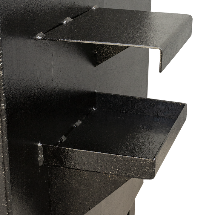 Two black, textured shelves, one above the other, extending from a black vertical surface. The top shelf has a smooth, curved front edge, while the bottom shelf is a flat tray with raised edges, showing visible welds attaching them to the surface