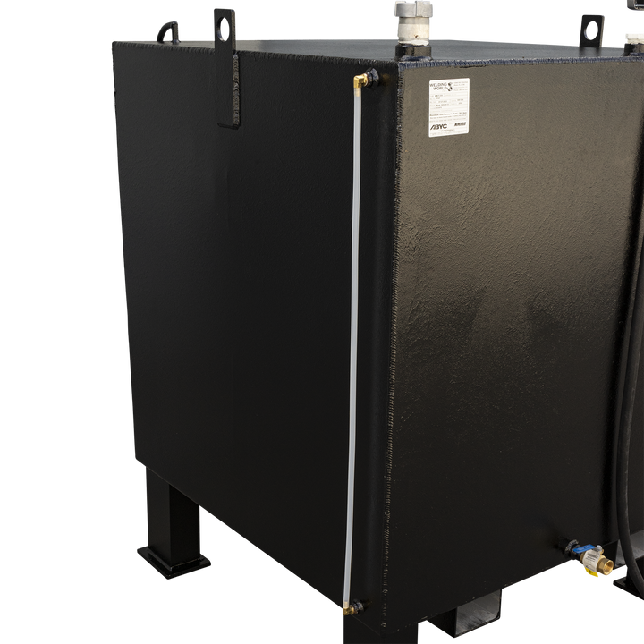 A black, rectangular fuel tank with a textured finish, viewed from a slight angle. It has four sturdy legs, one visible in the front left. A white translucent tube runs vertically along the left side, and a white cap is on the top surface. A black hose is visible on the right side of the tank, and a brass valve with a blue handle is near the bottom right. A white label is affixed to the front of the tank