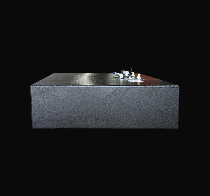 A front profile view of the Grady White 25 Sailfish auxiliary replacement fuel tank, highlighting its low-profile rectangular body and premium textured black TarGard epoxy coating. This angle showcases the clean, seamless weld lines and the heavy-duty marine-grade aluminum construction. The top-deck hardware cluster is visible on the upper right, including the fuel fill neck, brass fuel line pickups, and vent fittings. Precision-engineered by Welding World for a guaranteed 100% drop-in fit.