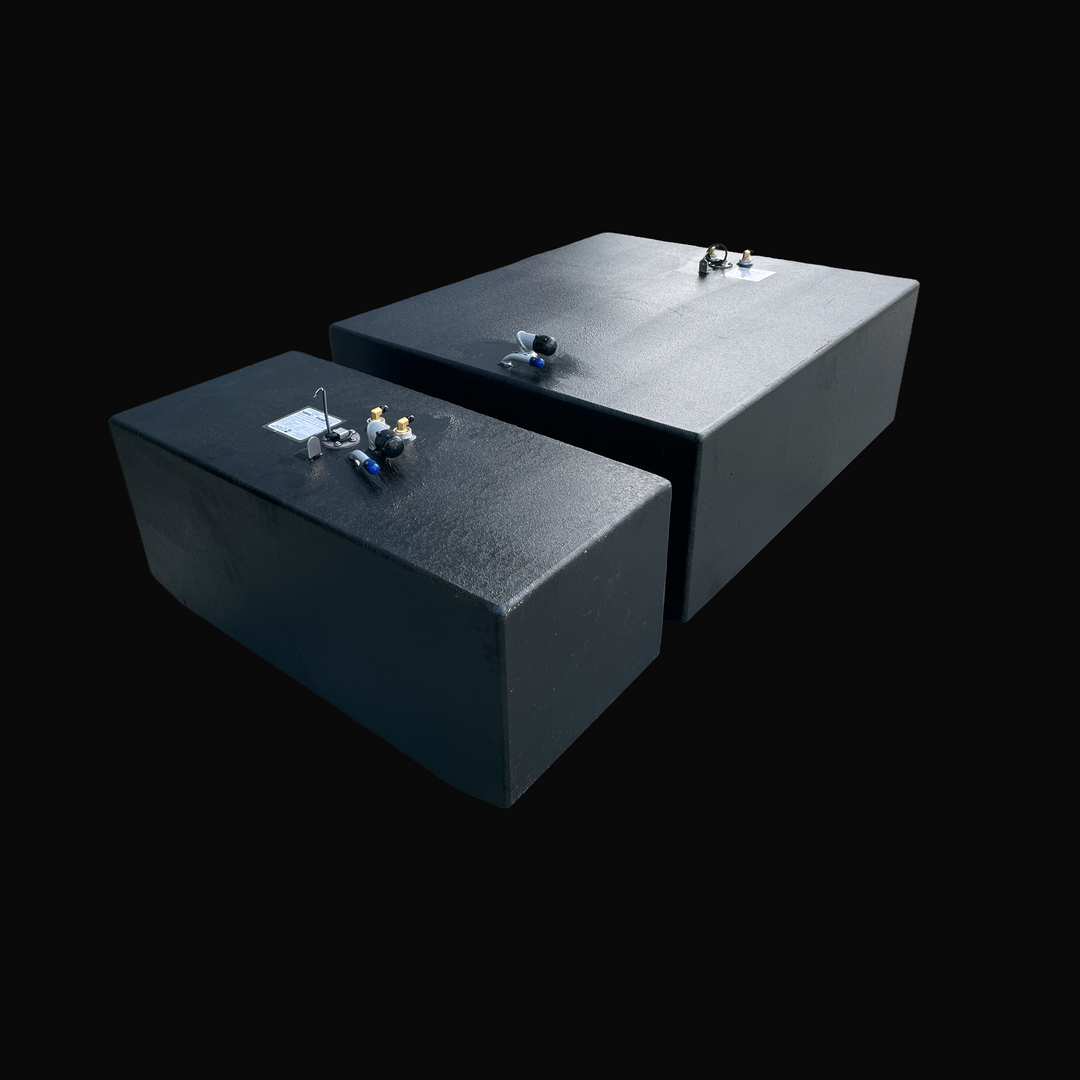 A studio high-angle isometric view displaying both the main and auxiliary tanks of a physical, finished black encapsulated Grady White 272 Sailfish OEM replacement marine fuel tank combo set from file image_2a302f.jpg, isolated against a black background. Precision-fabricated from heavy-gauge marine-grade 5052-H32 aluminum, both custom rectangular bodies are fully encapsulated in a protective, textured black TarGard epoxy coating to resist severe saltwater pitting and bilge moisture decay. Foreground deck h