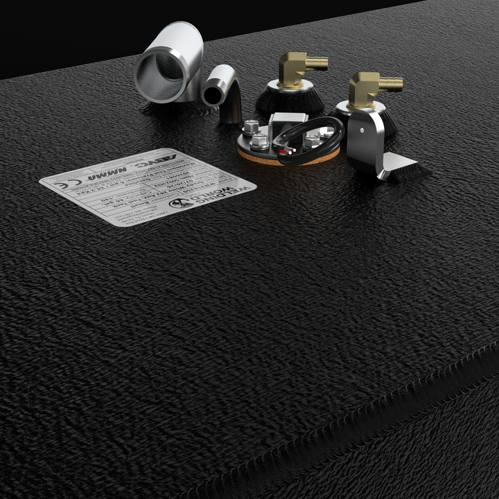 A macro studio close-up view of the top deck hardware cluster and specification tag on a physical, finished black encapsulated Grady-White 282 Sailfish Auxiliary OEM replacement fuel tank (66 gal) from file image_f147bd.jpg. The textured black TarGard epoxy coating covers the heavy-gauge marine-grade 5052-H32 aluminum tank deck, highlighting clean TIG-welded corner seams. The central fitting cluster includes a 90-degree aluminum fuel fill neck, a curved vent line, dual high-flow brass 90-degree fuel pickup 