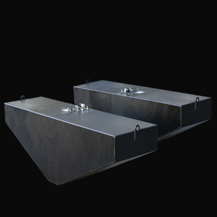 Photo of two black OEM replacement fuel tanks for a 2007 Grady-White 360 Express boat, each with a 185-gallon capacity. The tanks have a textured anti-corrosion coating, top-mounted fittings including sender ports, fill and vent fittings, and lifting tabs on the front and rear