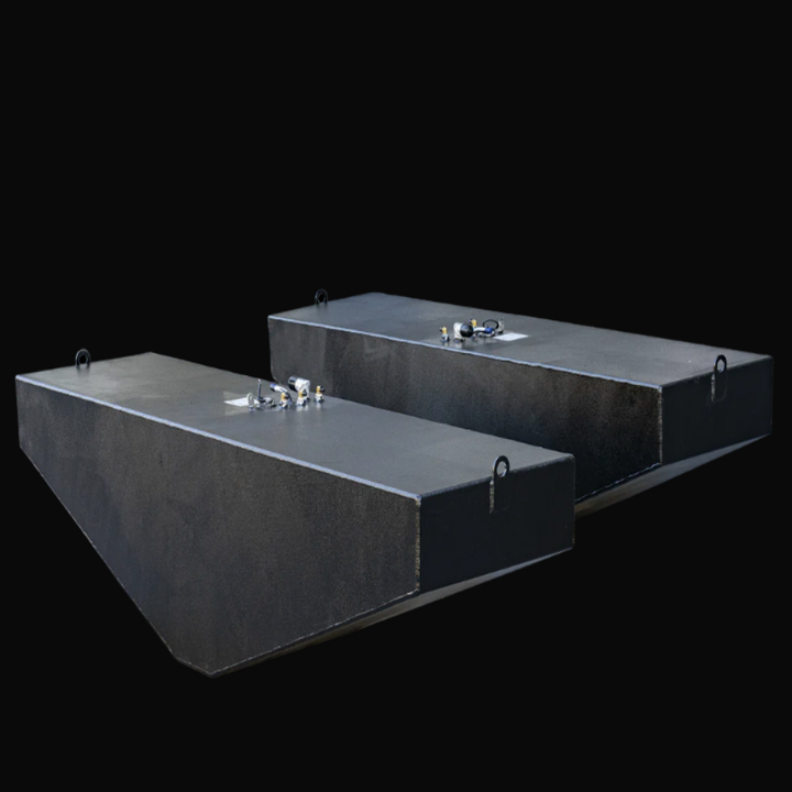 Photo of two black OEM replacement fuel tanks for a 2007 Grady-White 360 Express boat, each with a 185-gallon capacity. The tanks have a textured anti-corrosion coating, top-mounted fittings including sender ports, fill and vent fittings, and lifting tabs on the front and rear