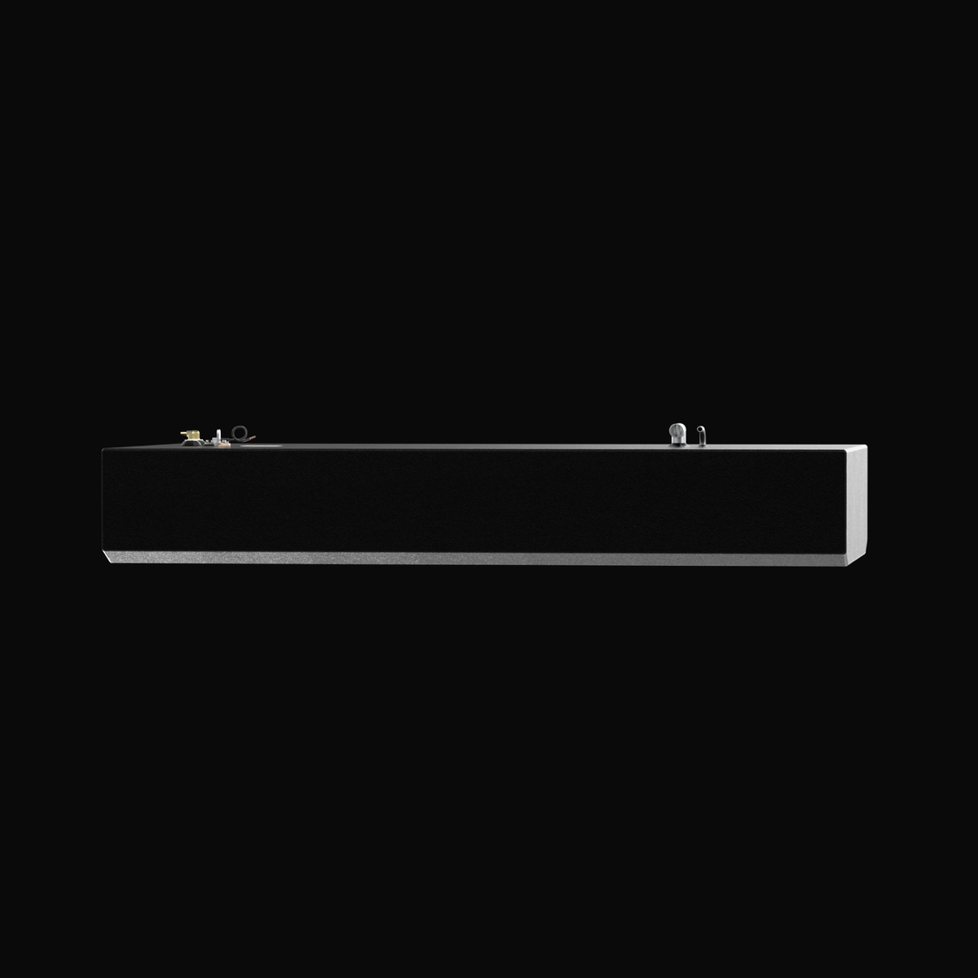An eye-level studio side profile view of a physical, finished black encapsulated Grady White Freedom 255-257 OEM replacement marine fuel tank (135 gal) from file image_990bc3.png, isolated against a black background. Precision-fabricated from heavy-gauge marine-grade 5052-H32 aluminum, the long rectangular body displays a tapered V-bottom deadrise angle along the lower edge designed to rest flush within the vessel's center-cavity bilge compartment. The body is fully encapsulated in a protective, textured bl