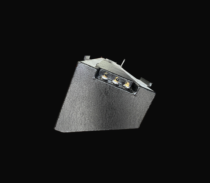 A close-up end elevation perspective view of a single physical, finished black encapsulated Jupiter 31 Cuddy port or starboard OEM replacement saddle fuel tank (105 gal) from file image_4a9222.jpg, isolated against a black background. This detailed end shot highlights the custom-angled cross-sectional profile precision-fabricated to match the vessel's outboard hull deadrise geometry. Heavy-gauge marine-grade 5052-H32 aluminum is coated in a textured, anti-corrosive black TarGard epoxy coating to protect aga