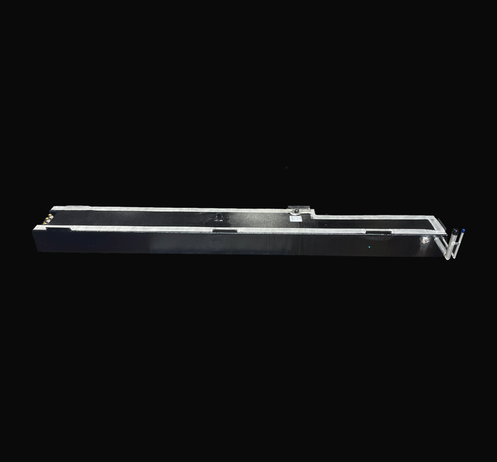 A full-length, side elevation studio view of a single physical, finished black encapsulated Jupiter 31 Cuddy port or starboard OEM replacement saddle fuel tank (105 gal) from file image_4a8dfc.png, isolated against a black background. This side-profile perspective emphasizes the extra-long, custom-contoured saddle profile designed to sit within the vessel's outboard hull stringer bays. Precision-fabricated from heavy-gauge marine-grade 5052-H32 aluminum, the body is coated in a protective, textured black Ta