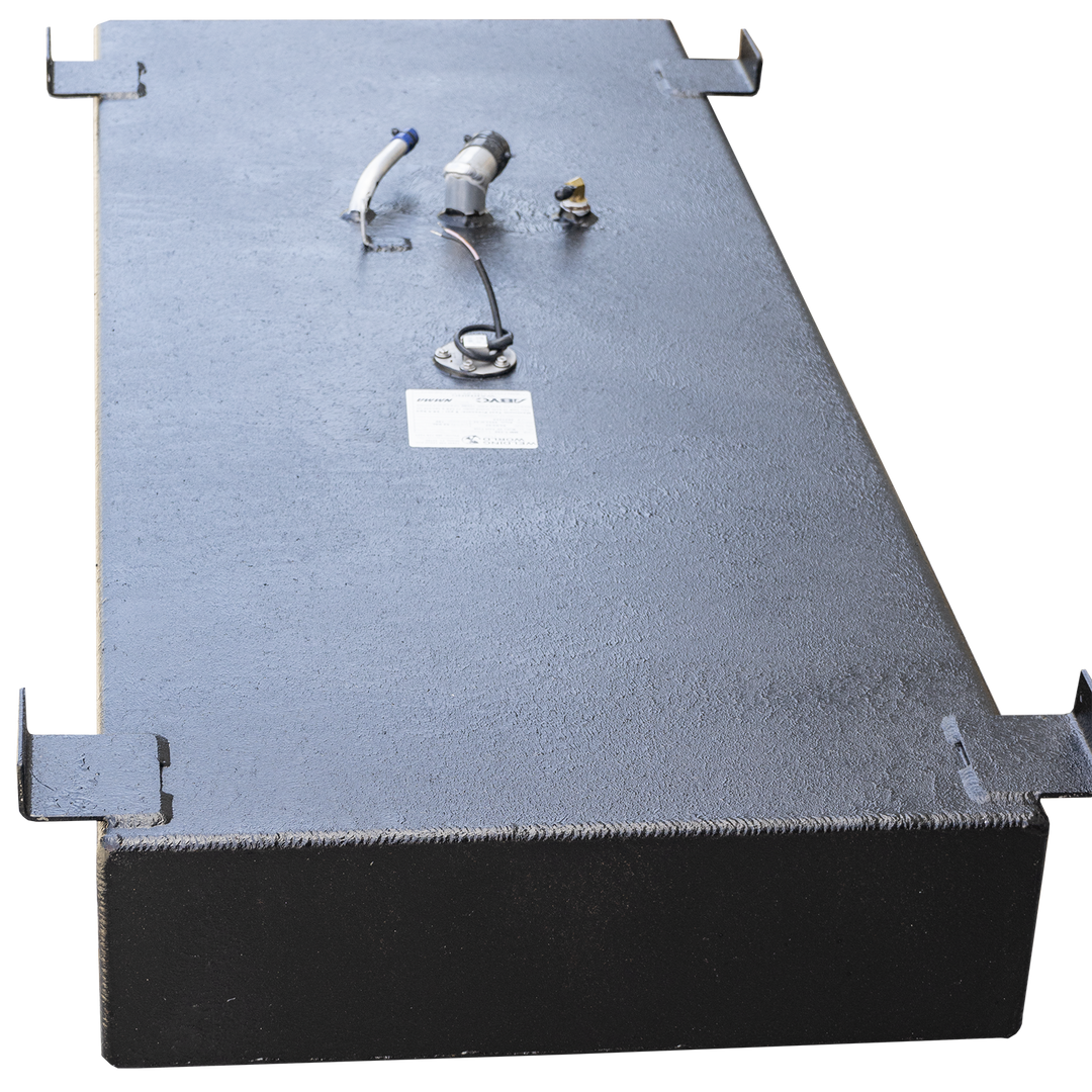 A black, rectangular boat fuel tank with a textured surface, shown from a high angle. It has several mounting brackets along its perimeter. Various fittings and ports are visible on the top surface, including a white and blue hose connection, two small metal posts, a circular gauge with wires, and a small white label