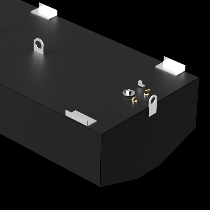  A black, rectangular Mako 253 Walkaround 2002 - 140 gal. OEM Replacement Belly Fuel Tank is shown from an elevated perspective against a dark background. The top surface of the tank features several metal components: four L-shaped brackets at each corner, two circular eye bolts, two brass-colored fittings, and a circular cap. The tank has angled bottom corners and a smooth, matte finish