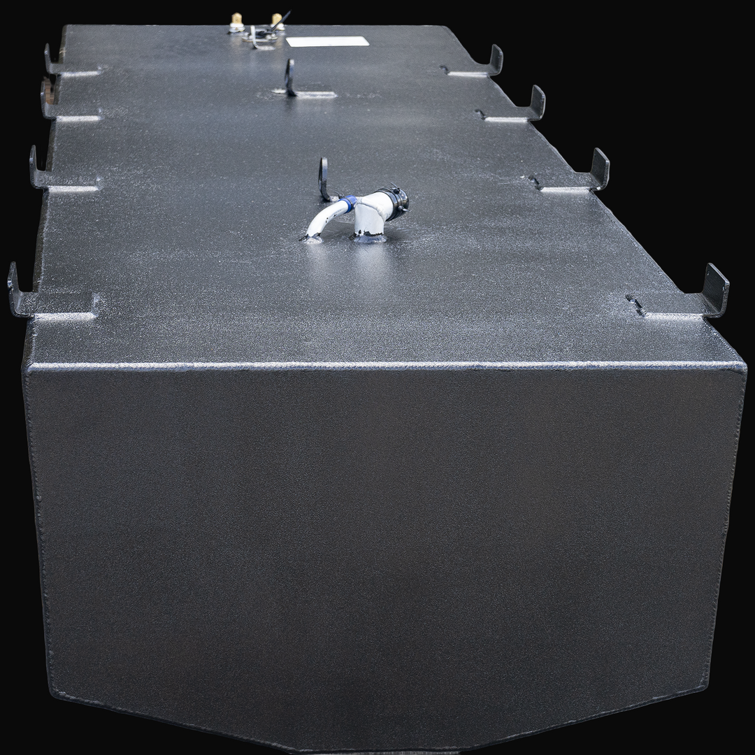 Large rectangular black OEM replacement belly fuel tank for Mako 261, 1990 model, with rounded front corners and multiple mounting brackets along the top edges. The top surface includes several fittings and connectors, including a white pipe with a black cap. The tank has a textured finish