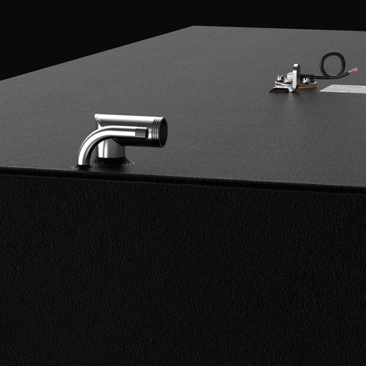Close-up macro view detailing the forward deck hardware and fittings on a custom marine aluminum fuel tank system. The image focuses on a welded stainless steel 90-degree fuel fill pipe assembly paired alongside an integrated vent line connection, set against a textured black TarGard epoxy coating over heavy-duty marine-grade 5052-H32 aluminum. In the background, a center-mounted electronic fuel level sending unit with wired connections, a grounding tab, and a partial view of the official certification spec