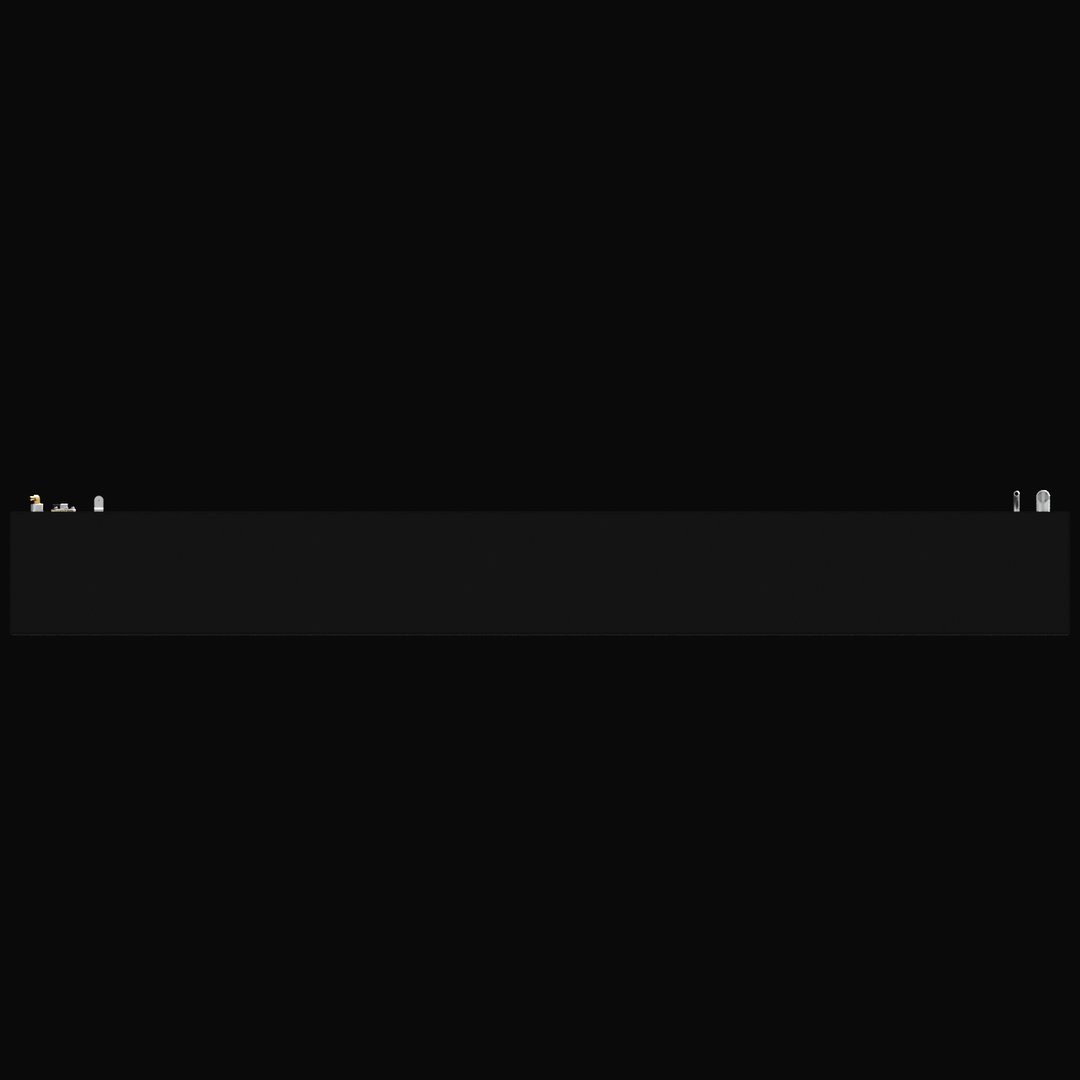 A black background with a long, horizontal, dark gray panel featuring various small metallic and plastic fittings, ports, and valves arranged along its top edge

