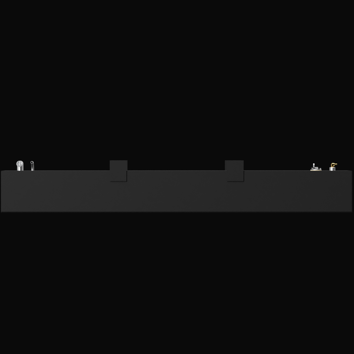 A 3D render showing a long side profile of a dark grey boat fuel tank, highlighting the various fittings and two indented mounting tabs visible along the top edge, against a black background.
