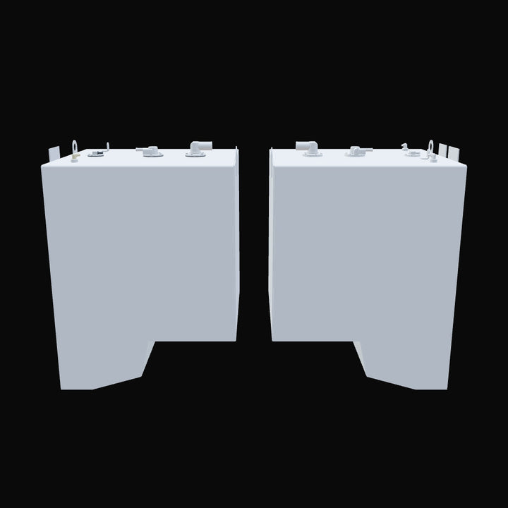 Front view of two light gray industrial fuel tanks side by side on a black background, each with various pipe fittings, lifting hooks, and angled bottom corners; both tanks feature flat tops with visible connection points and cutouts at the lower front edge