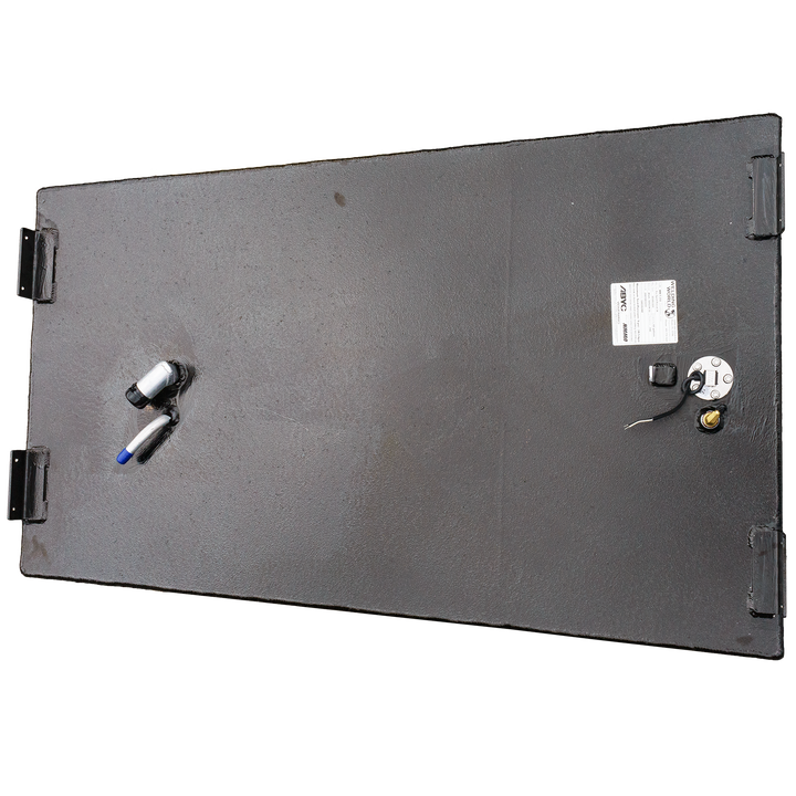 An overhead view of a black, rectangular marine fuel tank with a textured finish. Four black mounting brackets are visible at the corners of the top surface. Towards the right, a white product label is affixed next to a circular fuel sender unit with attached wires and a brass fitting. On the left side, two silver-colored hose fittings, one with a blue cap, protrude from the tank's surface. The tank is displayed against a black and grey checkered background