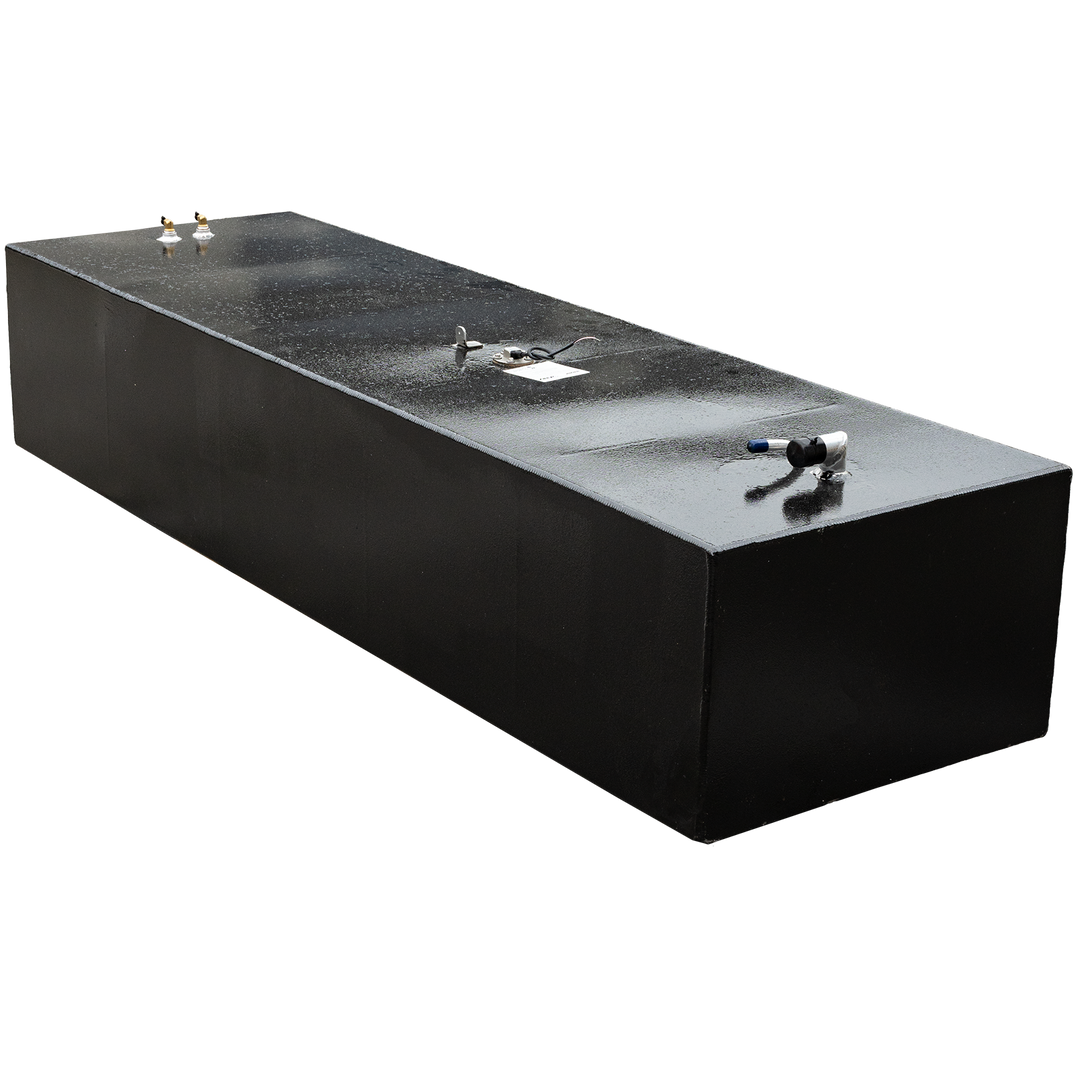 A dark, elongated, rectangular fuel tank with a slightly textured top surface, featuring various metallic fittings and pipes, against a black and grey checkered background