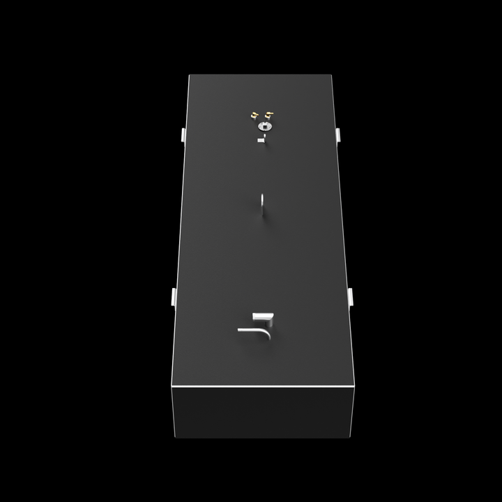 A top-down view of a dark grey, elongated rectangular fuel tank, set against a black background. The tank features golden-colored fittings, a circular silver cap, a straight pipe, an L-shaped pipe, and a D-ring on its top surface. White brackets are visible along the long sides, and a thin white line outlines the top edge