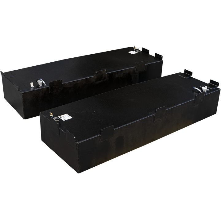 Two black, rectangular fuel tanks with a rough, textured finish are positioned against a black and gray checkered background. The tanks, likely for a Pursuit 2655 1995 model, each have a capacity of 117 gallons. Various metal fittings and connectors are visible on the top surfaces of both tanks. The tank in the foreground is angled slightly, and the second tank is positioned behind it