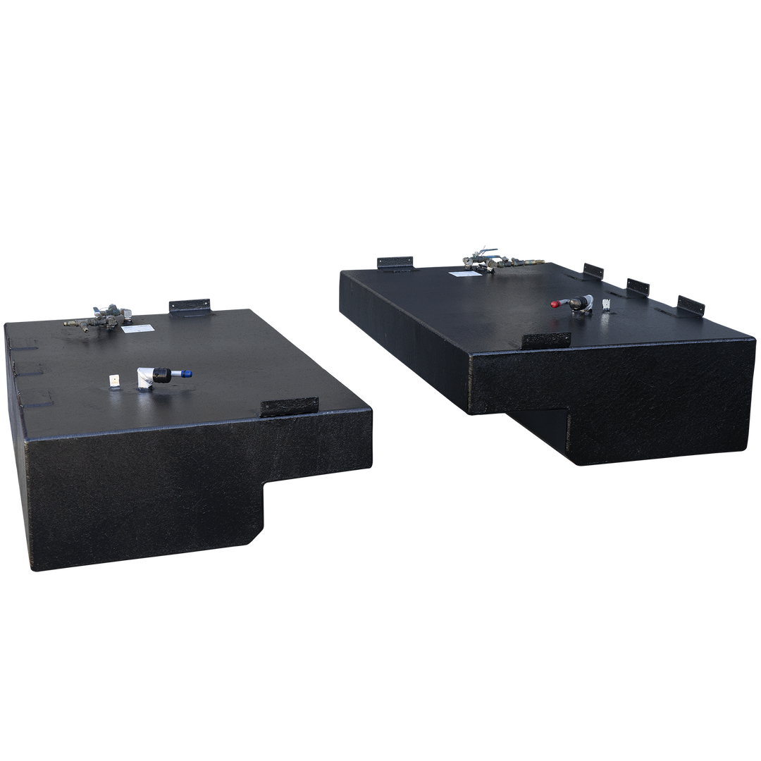 A matching pair of black, textured boat fuel tanks, presented as a port and starboard saddle tank set against a checkered background. The two tanks are arranged diagonally and are mirror images, each with a large rectangular body and a prominent step-down notch on its lower inboard side. Both tanks feature multiple mounting tabs along their top edges. The tank in the foreground is viewed from its front corner, while the tank in the background is viewed from its rear corner